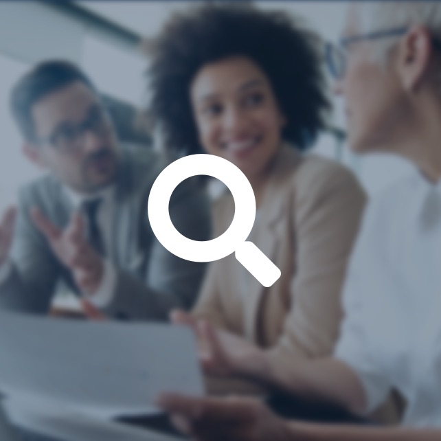 spyglass icon overlayed on coworkers meeting